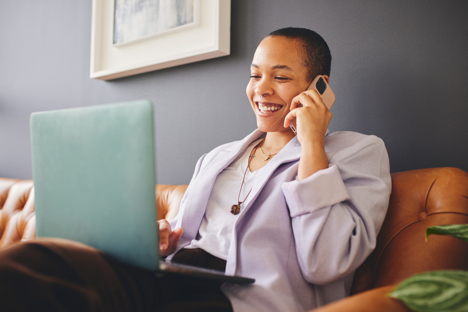 Realtor working on a laptop while on phone